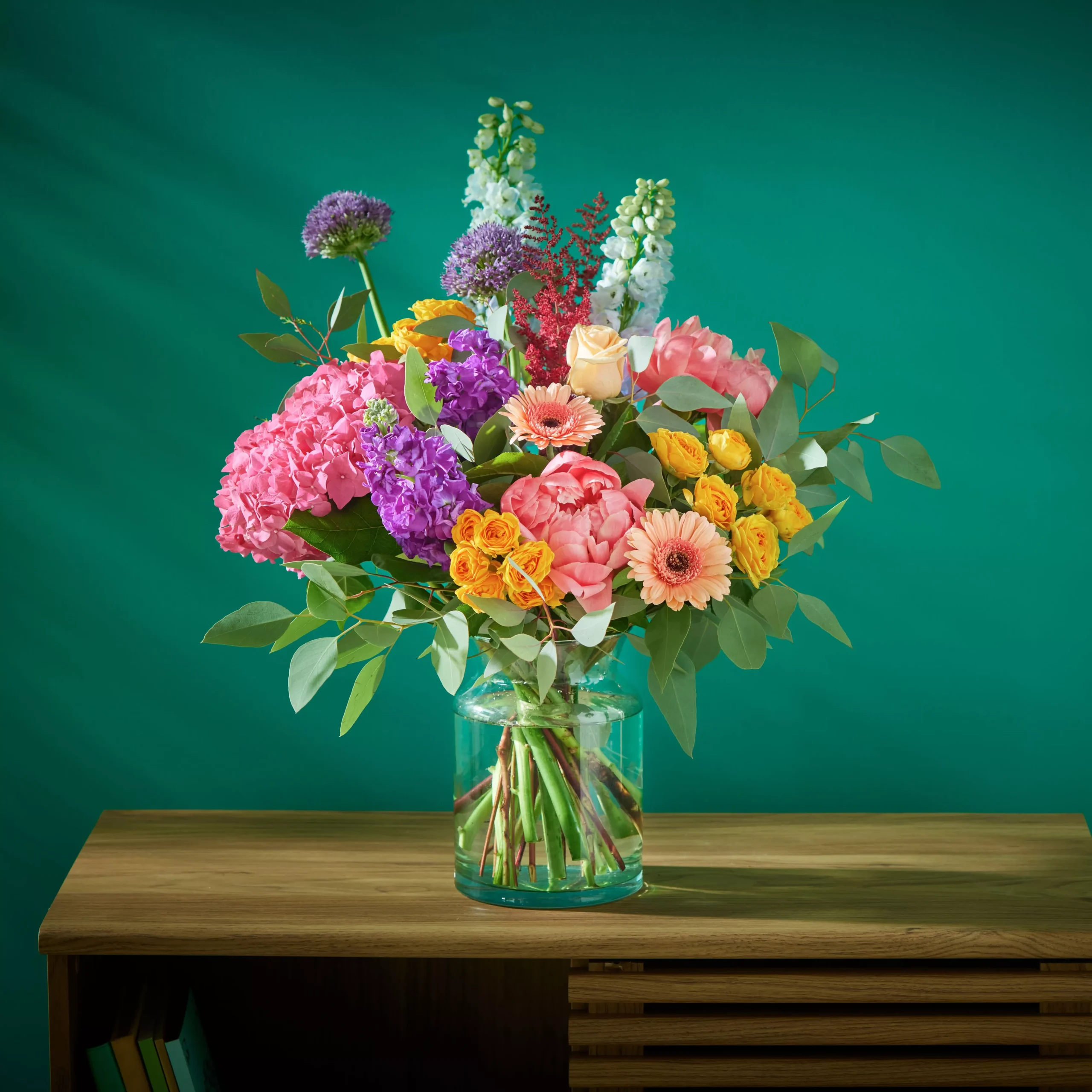 Colourful flower bouquet in a glass vase filled with water