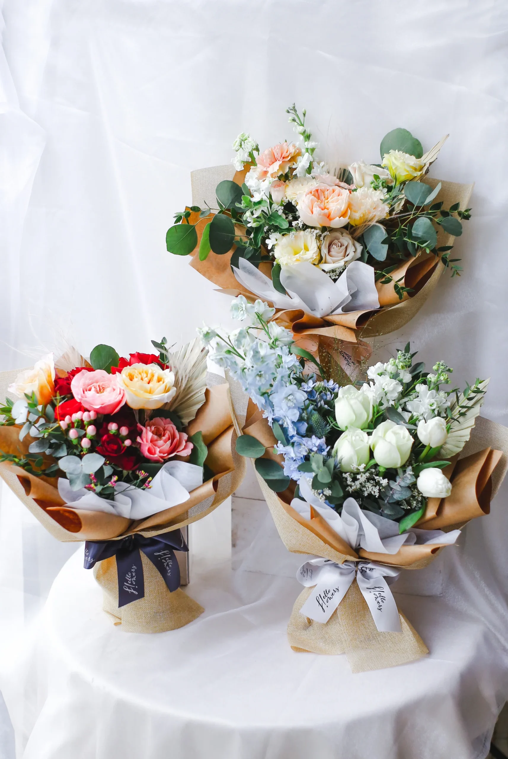 Three flower bouquets in different colours and styles